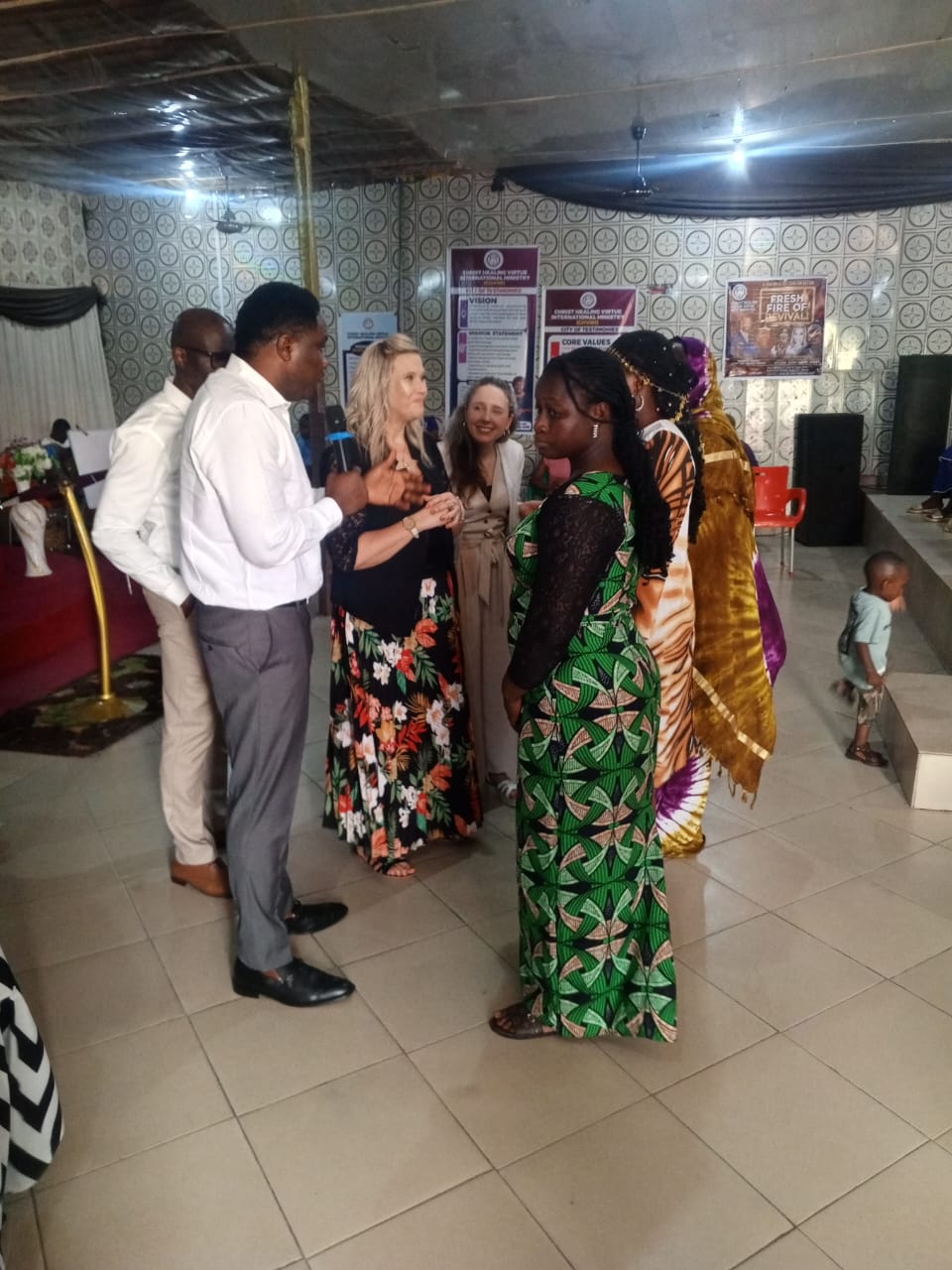Praying with children during a mission outreach